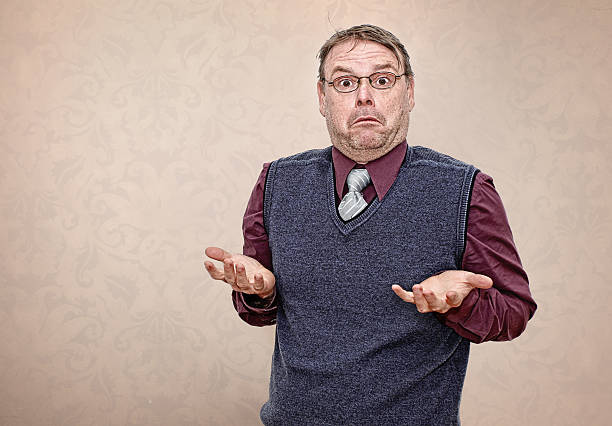 Portrait of a Confused Business Man Shrugging his Shoulders